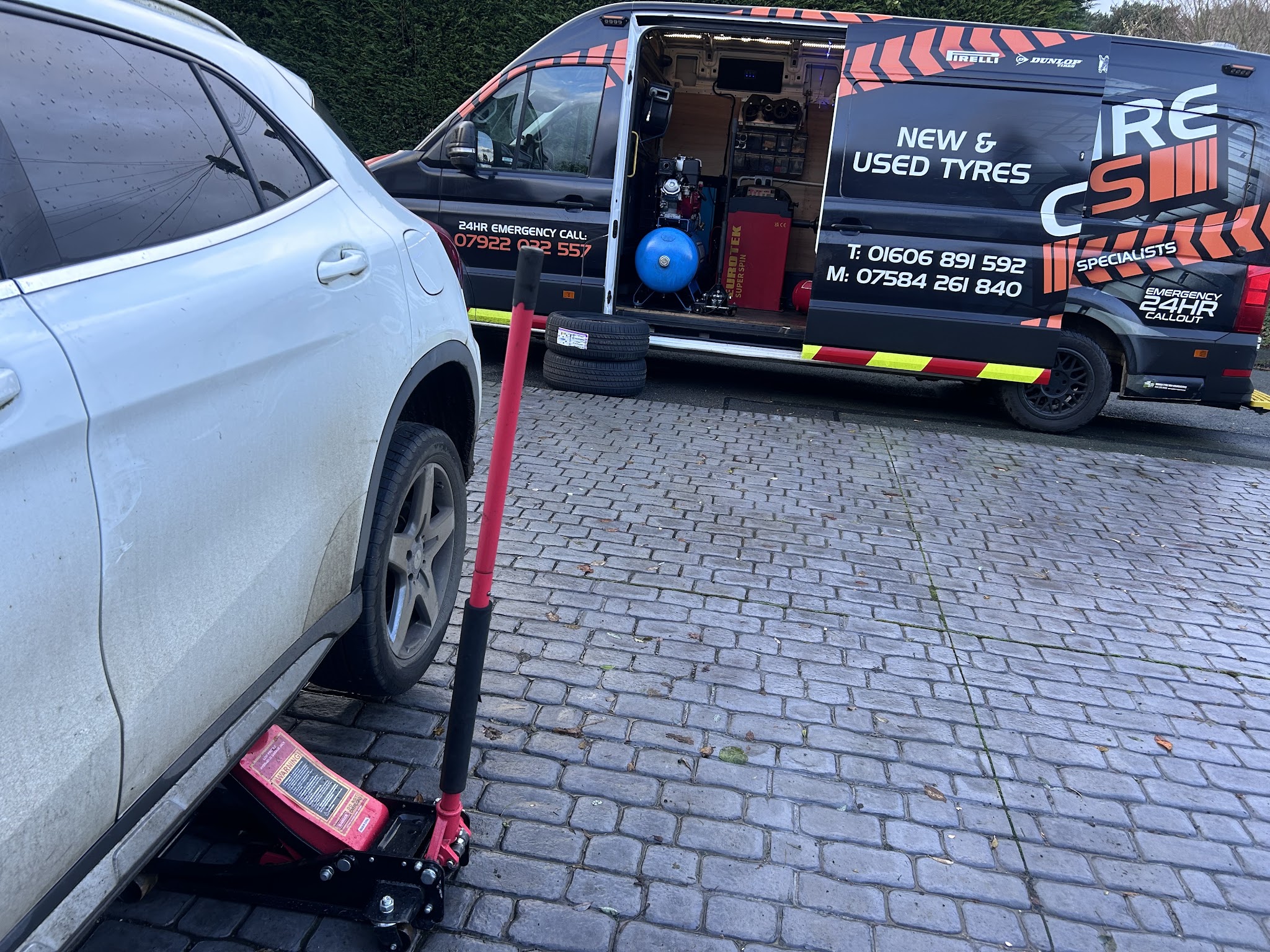 The Cheshire Tyres mobile tyre van on a customer's driveway, side door open showing the compressor and tyre changer